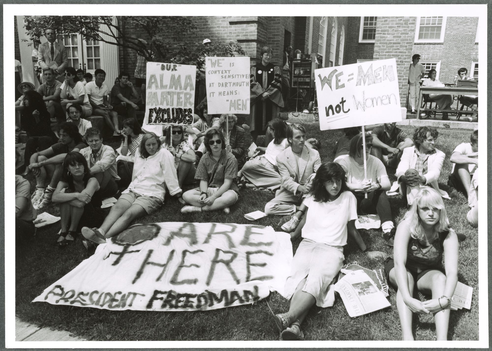 A black-and-white photograph of a protest against the lyrics of the Alma Mater.