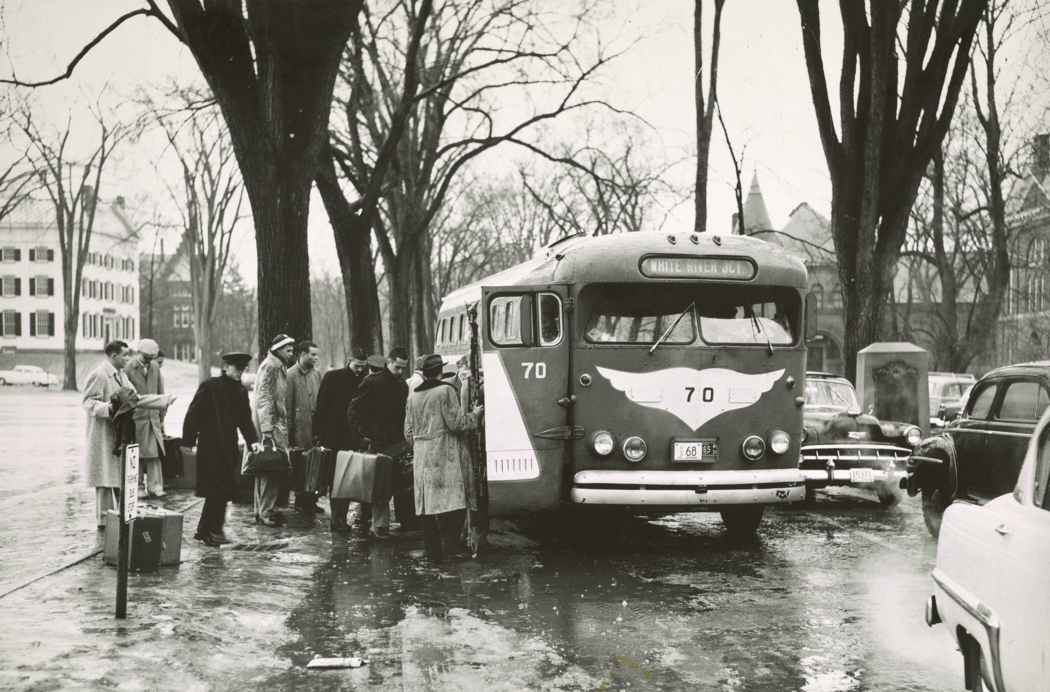 Men catch a bus to White River Junction
