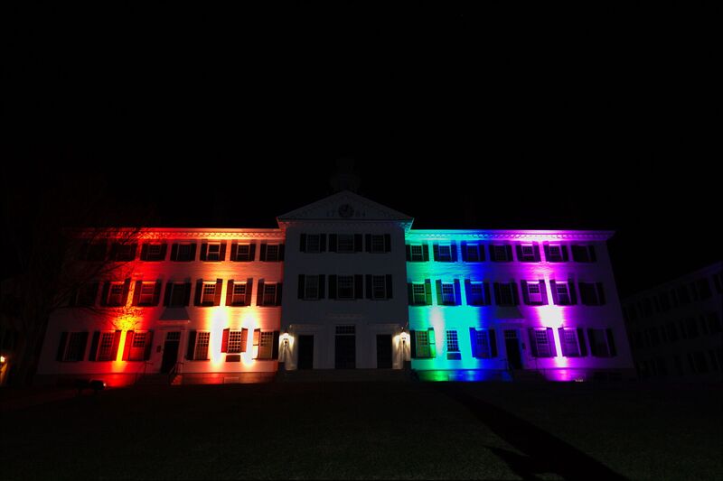 Dartmouth Hall lit by rainbow of colors in honor of Pride Week
