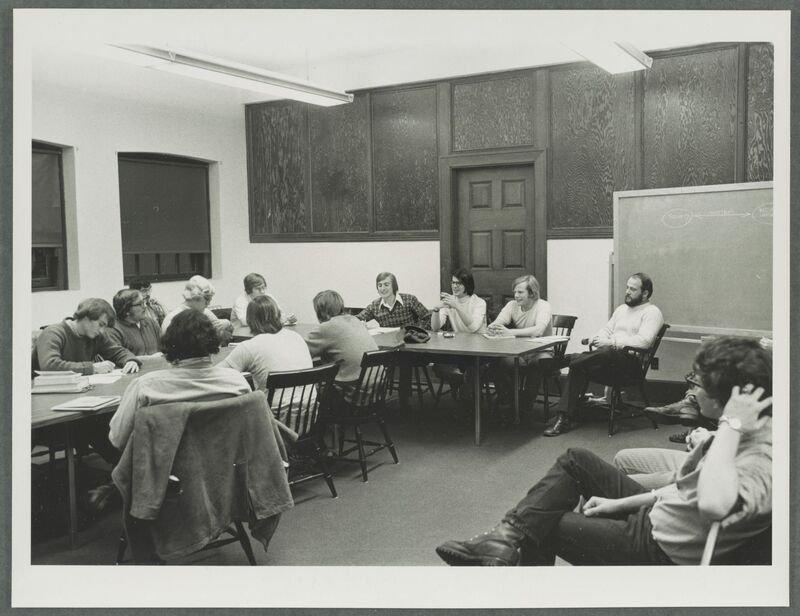 A black and white photograph from 1973 of a classroom filled with college men meeting as a part of the Inter-fraternity Council 