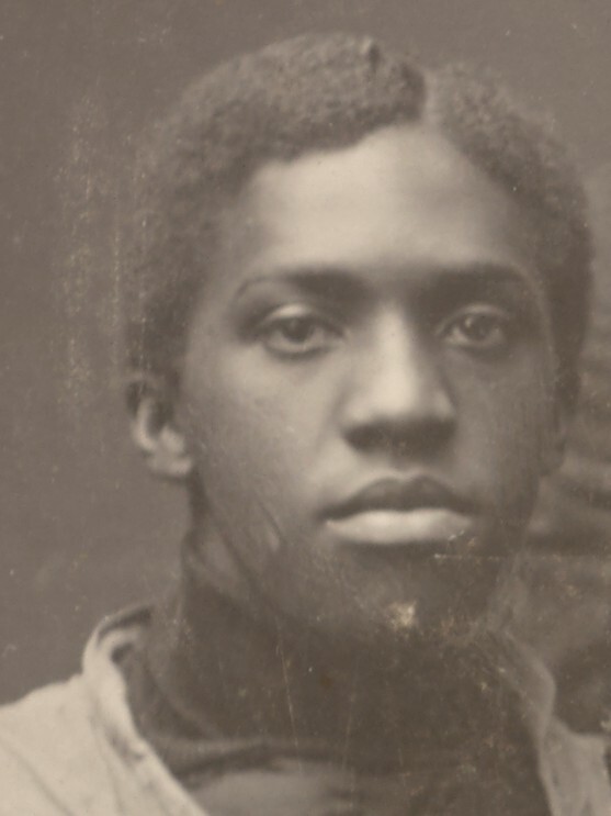 The face of Matthew Bullock, a 22 year old Black man with a serious expression, cropped from a football team photo